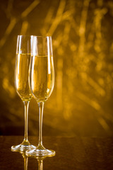 Gold scenery with two glasses of champagne for celebration important moments.