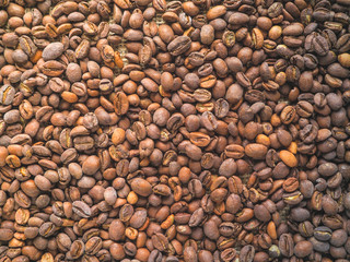 Coffee beans on burlap background.

