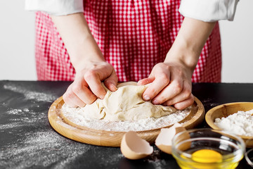 Making dough by female hands at bakery