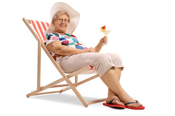 Elderly woman with a cocktail seated in a deck chair