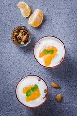 Overnight yogurt fruit muesli breakfast on concrete background. Top view, copy space.