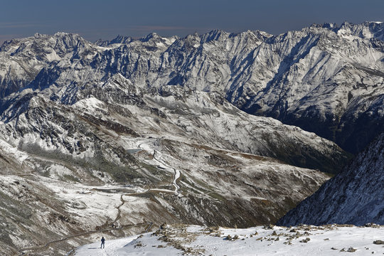 Austria, Tyrol, Oetztal, Soelden, woman in snowcapped landscape with view on Oetztal Glacier Road