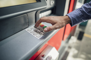Businessman Using Cash Machine