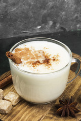 Christmas drink eggnog and ingredients on a green background