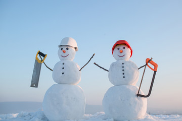 Snowman builder in winter in helmet.