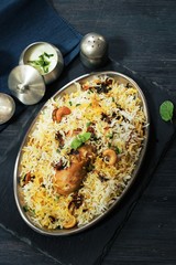 Hyderabadi chicken Dum biryani served with yogurt dip, top view