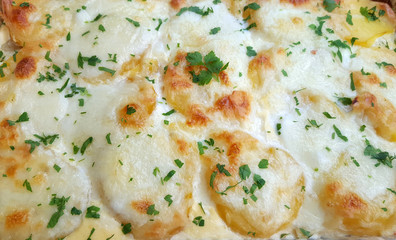 A casserole dish of au gratin potatoes with cheese