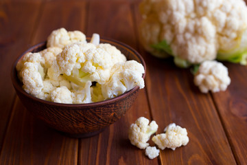 
Cauliflower in a plate on a dark wooden background. Vegetarian Breakfast