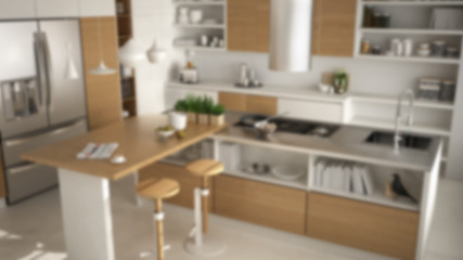 Blur background interior design, modern wooden kitchen with wooden details, close up, island with stools, white minimalistic