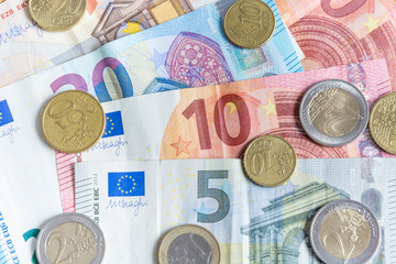 Euro bank notes and coins close up as background