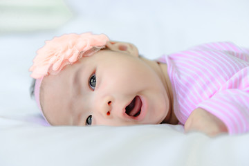 Close up asian baby girl cry on white wool carpet