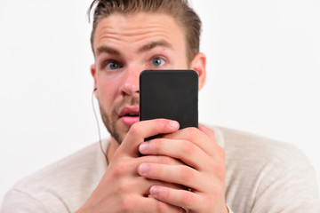 Macho with headphones listens to music. Man with surprised face