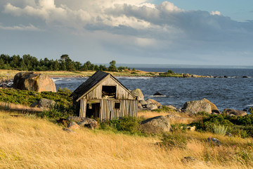 Obraz premium Abandoned houses in the Baltic Sea. Shore, nature and ruins facilities architecture concept. Mohni, small island in Estonia, Europe.