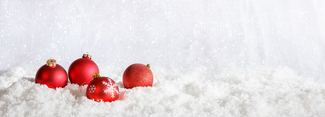 Red Christmas balls on Christmas snowy bokeh background