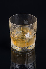 Whiskey with ice in rocks glass isolated on black background with clipping path