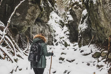 Deurstickers Girl walking in snow-covered mountain canyon © Bogdan