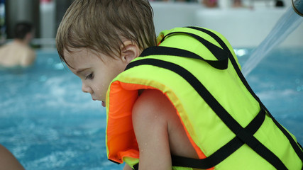 A boy swims in the pool. Relaxation and fun in the pool