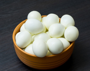 Bunch of boiled and peeled eggs in a bowl. Concept of food and organic farm products.