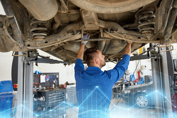 mechanic man or smith repairing car at workshop