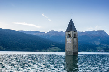 Church under water, drowned village, mountains landscape and peaks in background. Reschensee Lake Reschen Lago di Resia. Italy, Europe, S&uuml;dtirol, South Tyrol, Upper Adige, Alto Adige