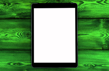 Tablet computer PC with blank screen mock up isolated on green wooden table background. Tablet on wood table. tablet white screen