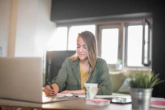 Young woman working at home on computer