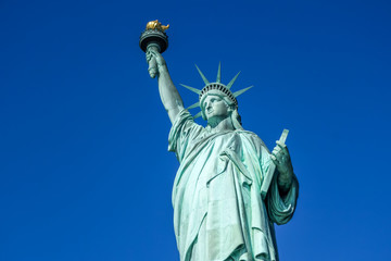 Statue of Liberty in detail on a very blue sky background, in Manhattan, Liberty Island, New York -...