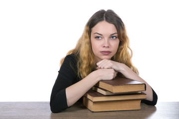 head of a girl lies on a pile of books isolated on a white background