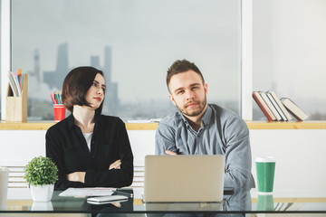 Young businessman and woman working on project