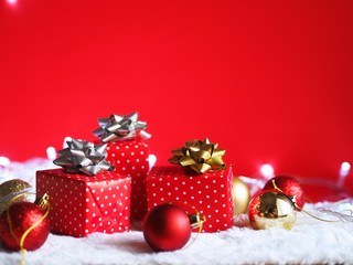 Gift box with Christmas ball decoration on red background,Christmas background concept.
