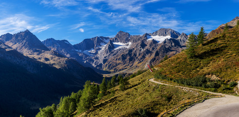Mountains, peaks and trees landscape, natural environment. Timmelsjoch High Alpine Road. Passo del...