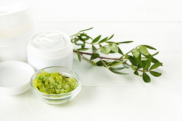 Spa concept with salt, mint, lotion, towel on white background