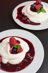 homemade pavlova meringue cake with raspberries and blueberries