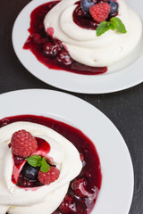homemade pavlova meringue cake with raspberries and blueberries