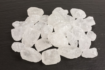 white rock sugar on slate plate background