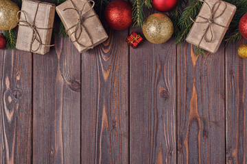 Christmas gift boxes and fir tree  on wooden background.