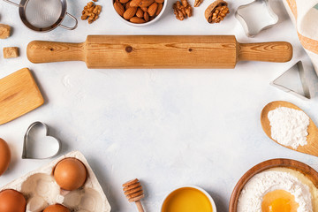 Fototapeta na wymiar Ingredients for baking - flour, wooden spoon, eggs.