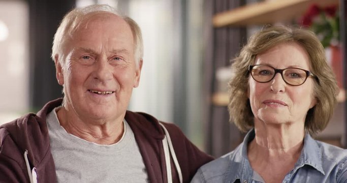 Portrait of attractive Senior Couple smiling into camera