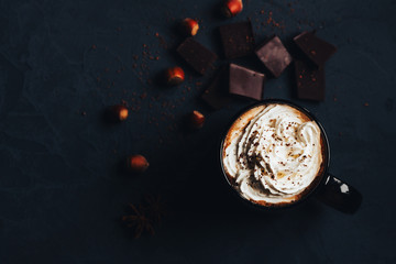 hot chocolate on a dark background with chunks of chocolate