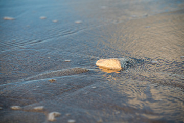Fototapeta na wymiar little rock in the surf