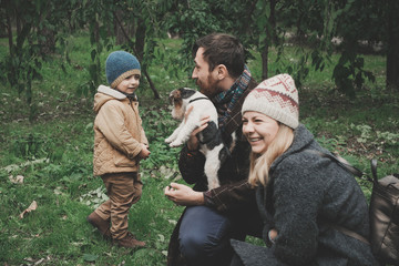 Parents give the child a dog fox terrier Outdoor