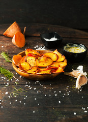 Sweet fried potatoes with spices, salt and sauce