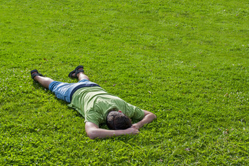 Fototapeta na wymiar Man lying on grass