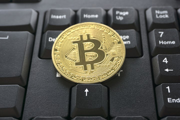golden bitcoin on keyboard