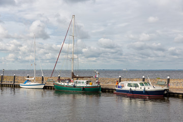 Fototapeta na wymiar Harbor of historic Dutch village Urk with modern sailing yachts moored to a pier