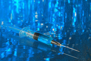 medical syringe, on an abstract background