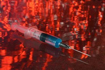 medical syringe with reflection, on an abstract background
