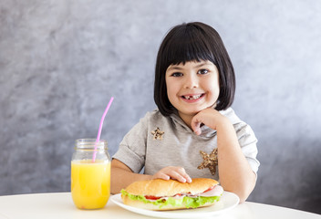 Portrait of little girl having breakfast at home