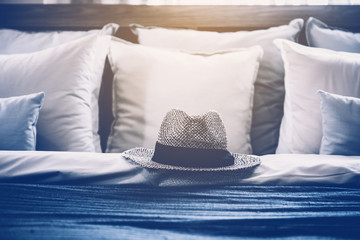 Morning bed maid-up with clean white pillows and bed sheets in bedroom. Close-up. Lens flair in sunlight.