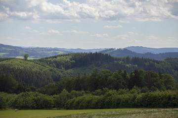 Fototapeta na wymiar Beautiful Czech summer landscape on hills with forest
